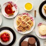 variety of baked and dessert foods on plates