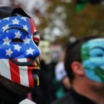 close up photo of person wearing guy fawkes mask