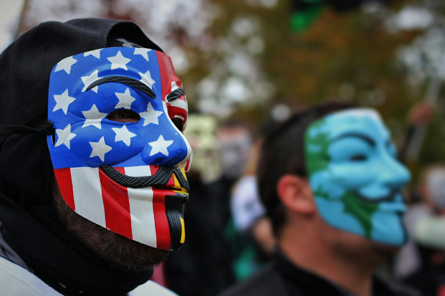 close up photo of person wearing guy fawkes mask