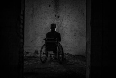 man sitting on wheelchair