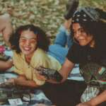 shallow focus photo of woman holding black am fm radio