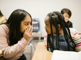 two girls gossiping with one another