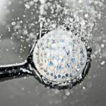 black shower head switched on