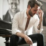 dramatic tattooed male sitting at piano