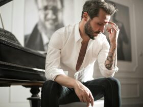 dramatic tattooed male sitting at piano