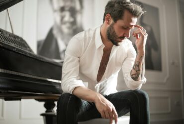 dramatic tattooed male sitting at piano