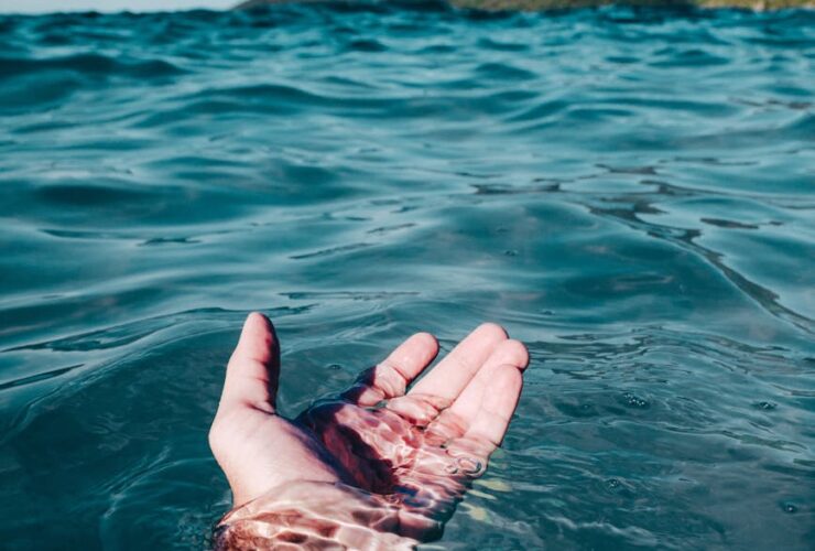 person soaking on body of water