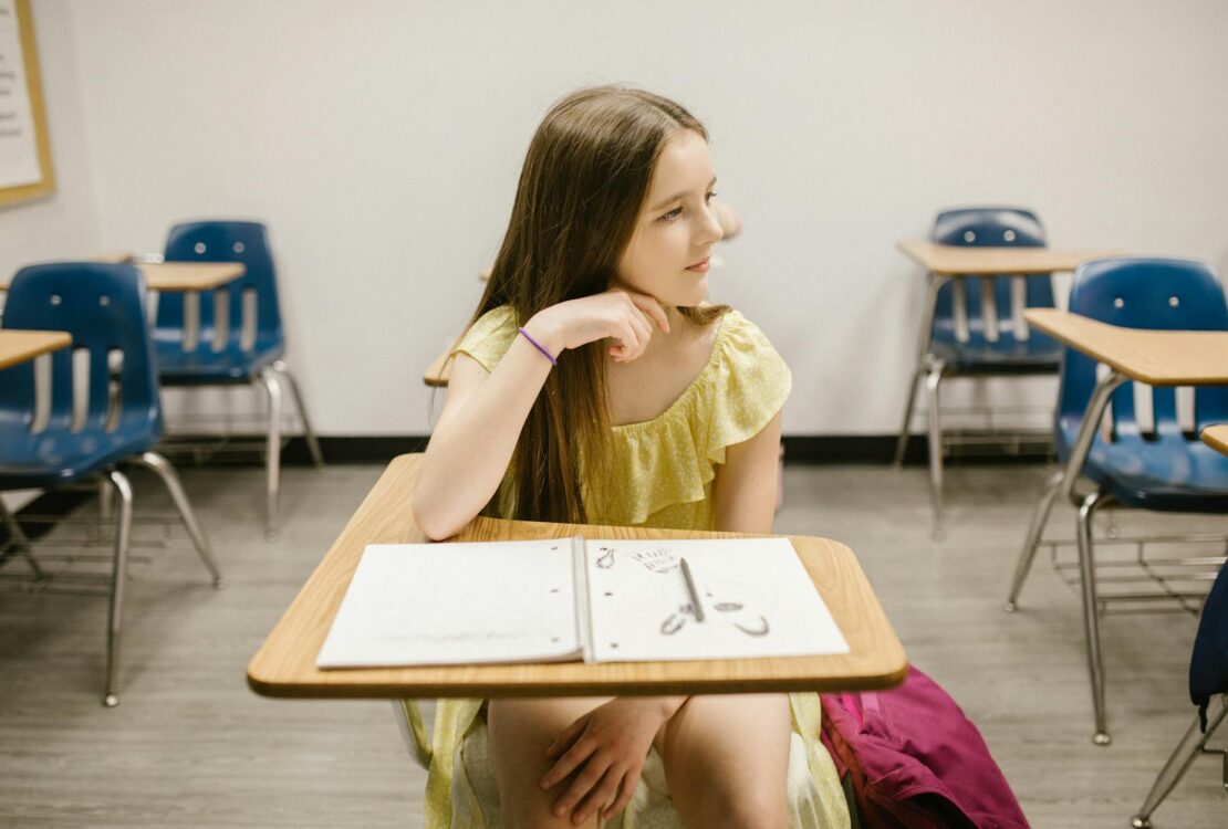 girl sitting on her desk